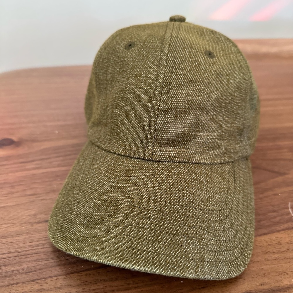 Storied Hats cap in olive green with a tan strap